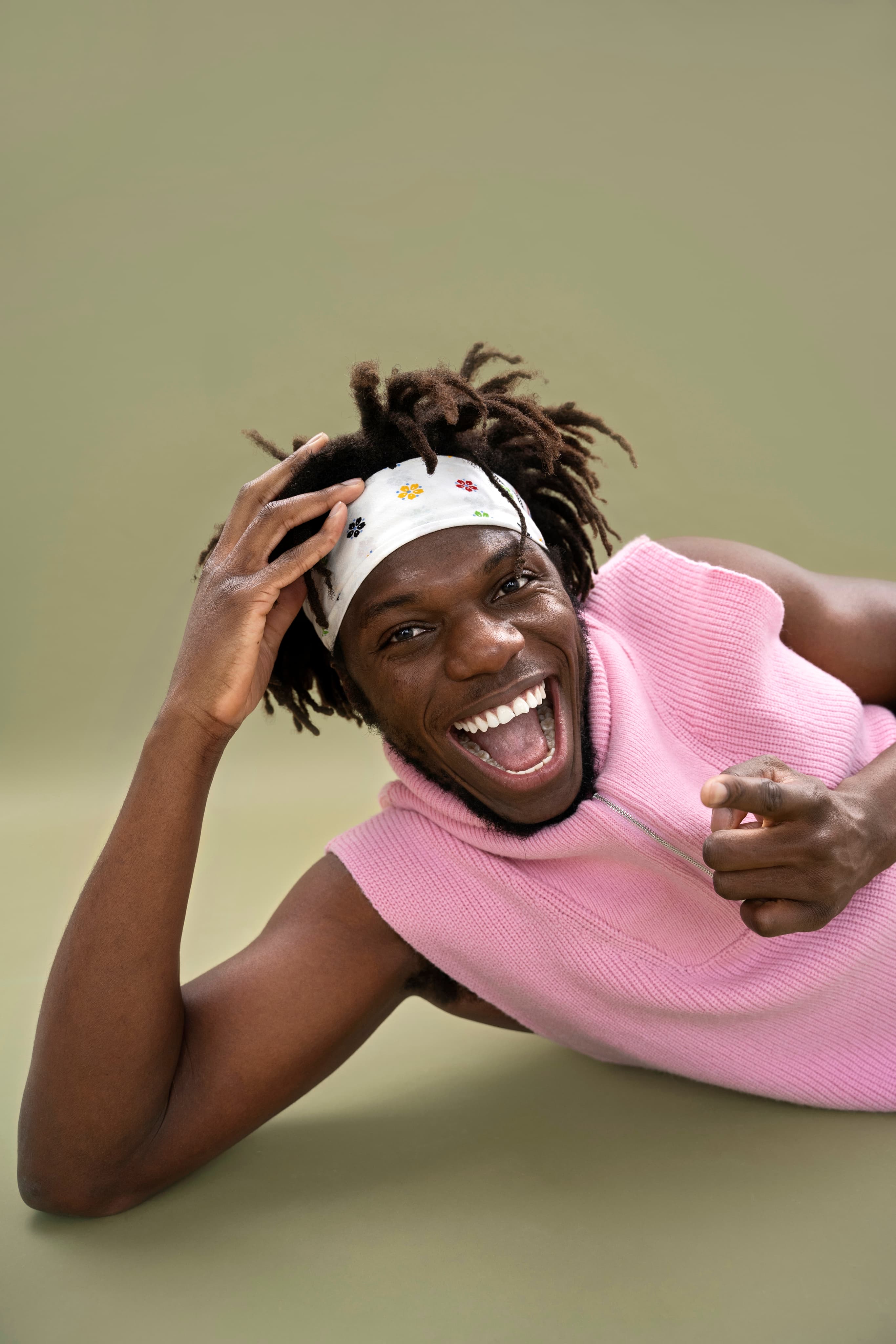 Smiling creative in a pink sleeveless top